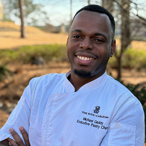 Portrait of The Ritz-Carlton Reynolds, Lake Oconee Pastry Chef, Micheal Gaddy, smiling at the camera.